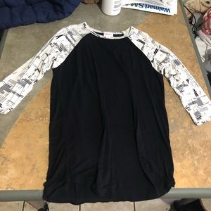This is a xS lu laroe half sleeve top, black with decorative sleeves